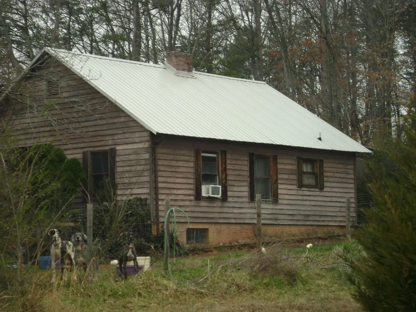 White metal roof on an old wood sided farmhouse, from a Metal Roof Installation job in Elbing